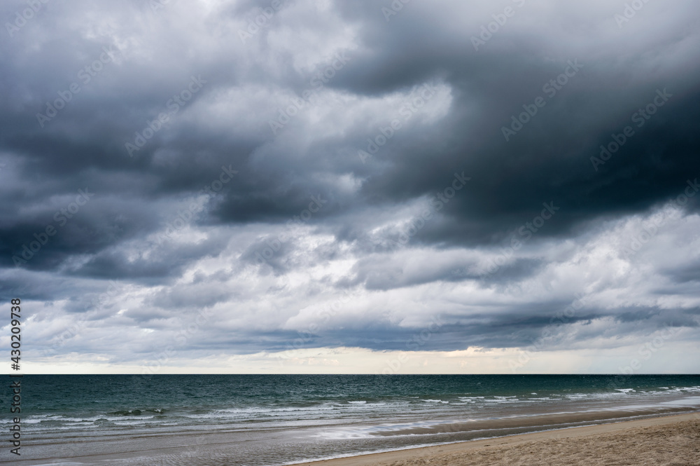 Dark dramatic sky and stormy clouds over the sea