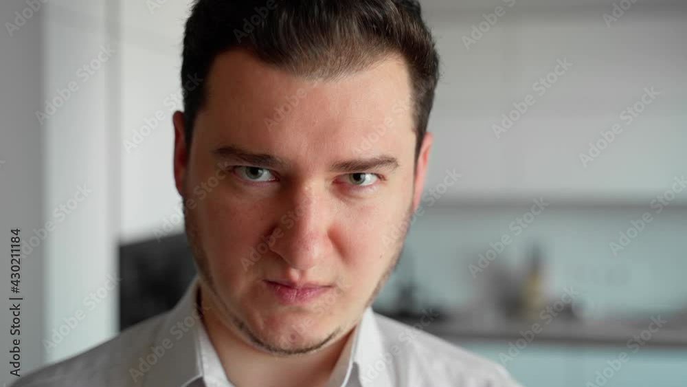 Portrait evil young man looking at camera. Angry person emotional watching intro the camera Portrait evil young man looking at camera. Angry person emotional watching intro the camera