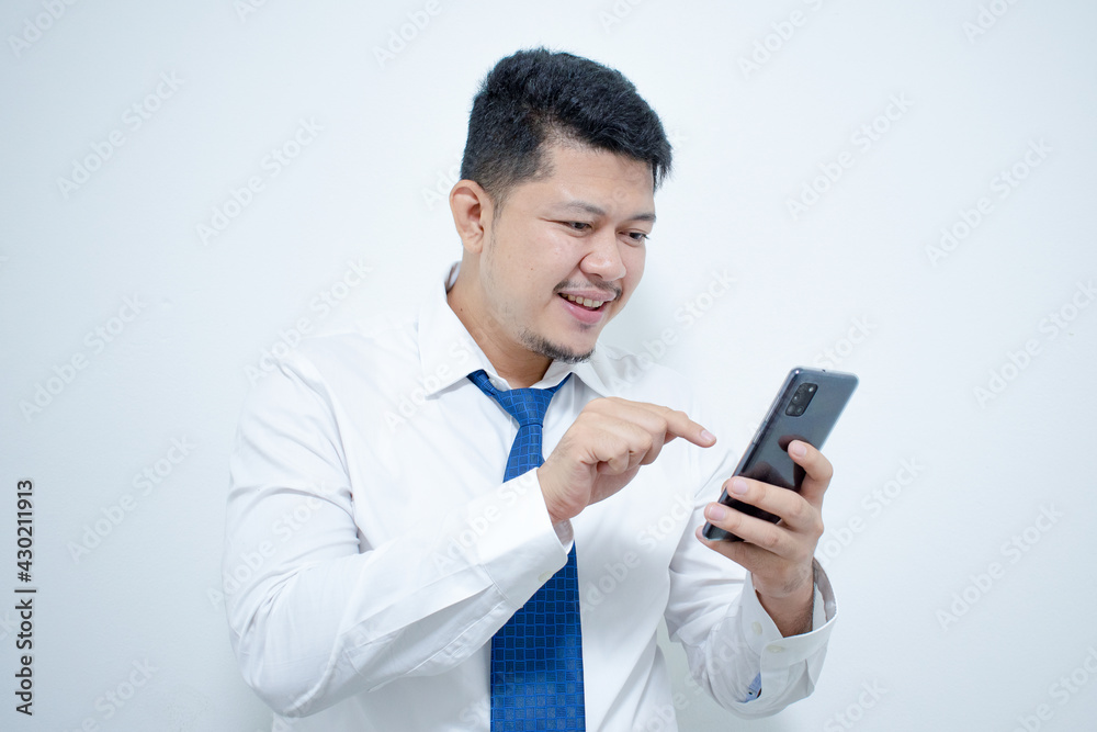 Young Asian businessman with mobile phone on light background Young Asian businessman with mobile phone on light background