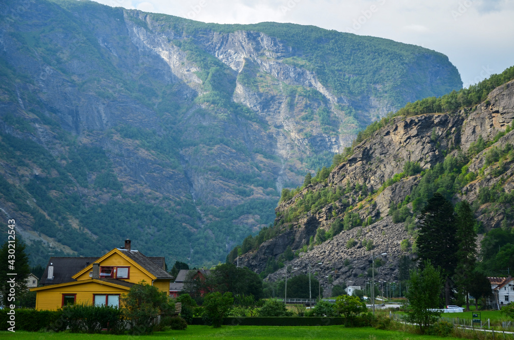 The beautiful and typical norwegian village of Flam with colorful houses and Sognefjord mountain landscape