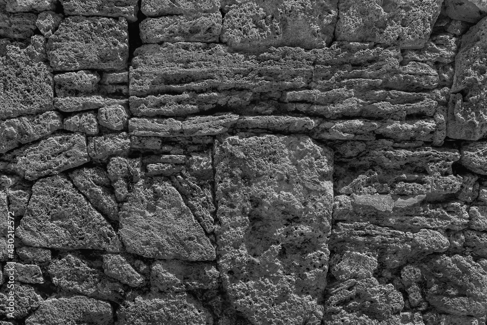 Old grungy retro dirty dusty brick wall of ancient city. Uneven pitted peeled surface stonewall of cellar worn. Ruined shabby stiff blocks. Hard solid messy ragged holes brickwall for 3D grunge design Old grungy retro dirty dusty brick wall of ancient city. Uneven pitted peeled surface stonewall of cellar worn. Ruined shabby stiff blocks. Hard solid messy ragged holes brickwall for 3D grunge design