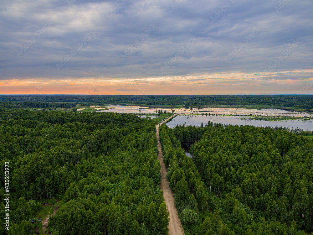 Bird's eye view of the sunset over the lake in the forest Bird's eye view of the sunset over the lake in the forest