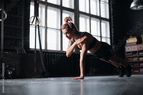Young girl doing sports in the gym. Atmospheric gym