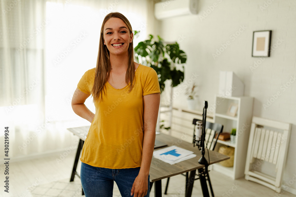 Portrait of young woman, standing in office, posing and looking at camera. Portrait of young woman, standing in office, posing and looking at camera.