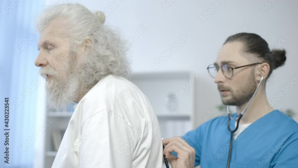 Medical practitioner examining patient's lungs with stethoscope, diagnosis Medical practitioner examining patient's lungs with stethoscope, diagnosis