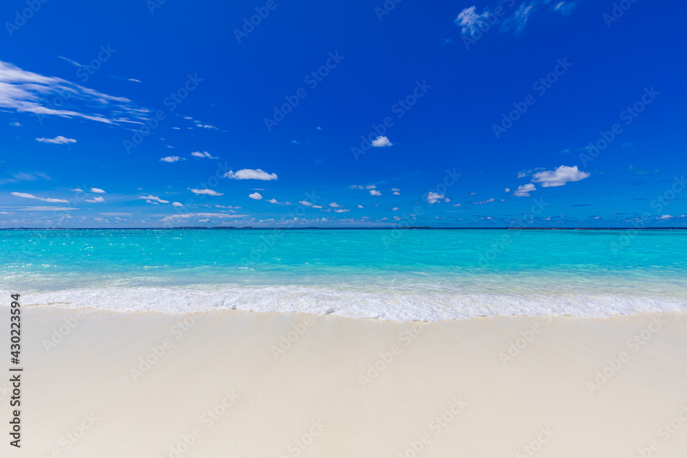 Closeup of sand on beach and blue summer sky. Panoramic beach landscape. Empty tropical beach and seascape. Vacation coast, shore blue sky, soft sand, calmness, tranquil relaxing sunlight, summer mood
