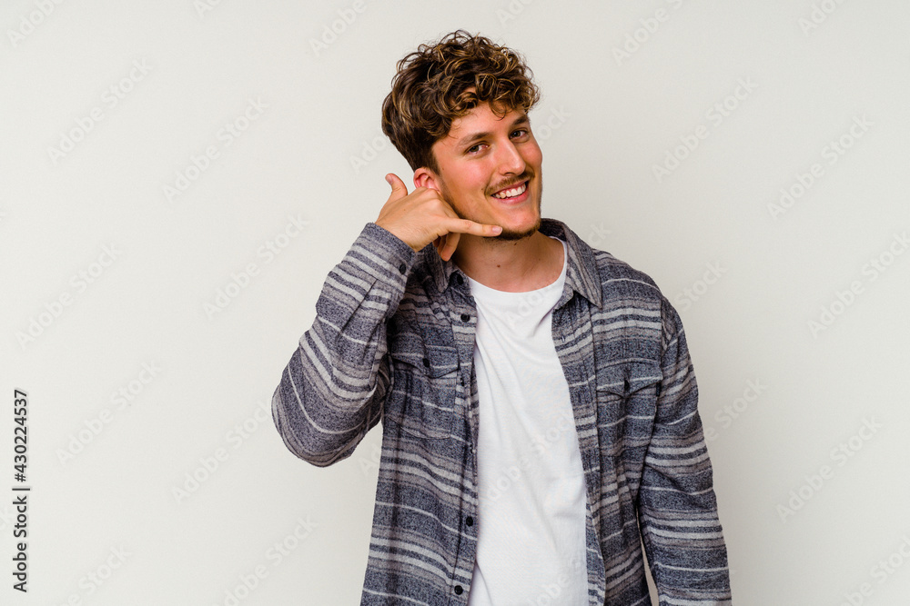 Young caucasian man isolated on white background showing a mobile phone call gesture with fingers. Young caucasian man isolated on white background showing a mobile phone call gesture with fingers.