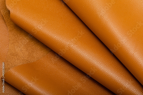brown mustard colored folded natural leather on the wooden table	
