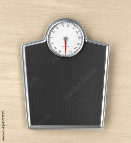 Mechanical weighing scale on wooden floor, top view