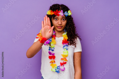 Young Hawaiian woman isolated on purple background standing with outstretched hand showing stop sign, preventing you.
