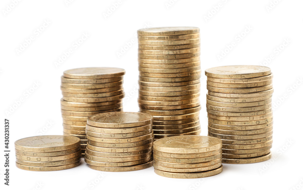 Coins stacked in columns of different heights on a white background. Isolated Coins stacked in columns of different heights on a white background. Isolated
