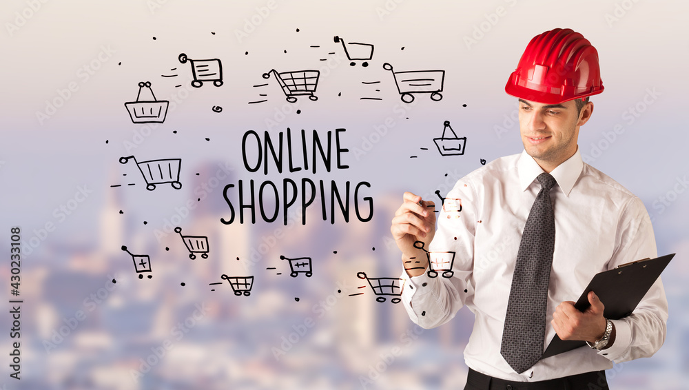 Young businessman with helmet drawing sale sign Young businessman with helmet drawing sale sign