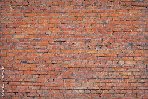 A fragment of a vintage brick wall of smooth masonry