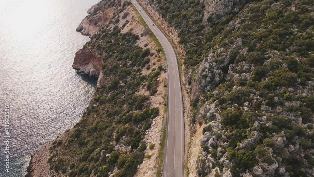 Aerial view of Coast Highway between sea and rocks. Summer road trip to sea at vacation Aerial view of Coast Highway between sea and rocks. Summer road trip to sea at vacation