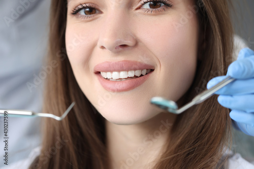 Portrait of woman with white beautiful teeth at dentist appointment