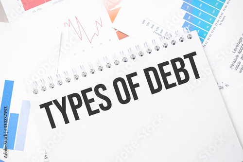 types of debt text on paper on the chart background with pen