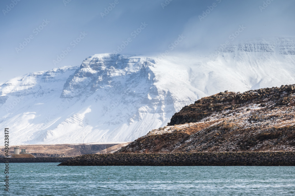Iceland, coastal landscape with snowy mountains