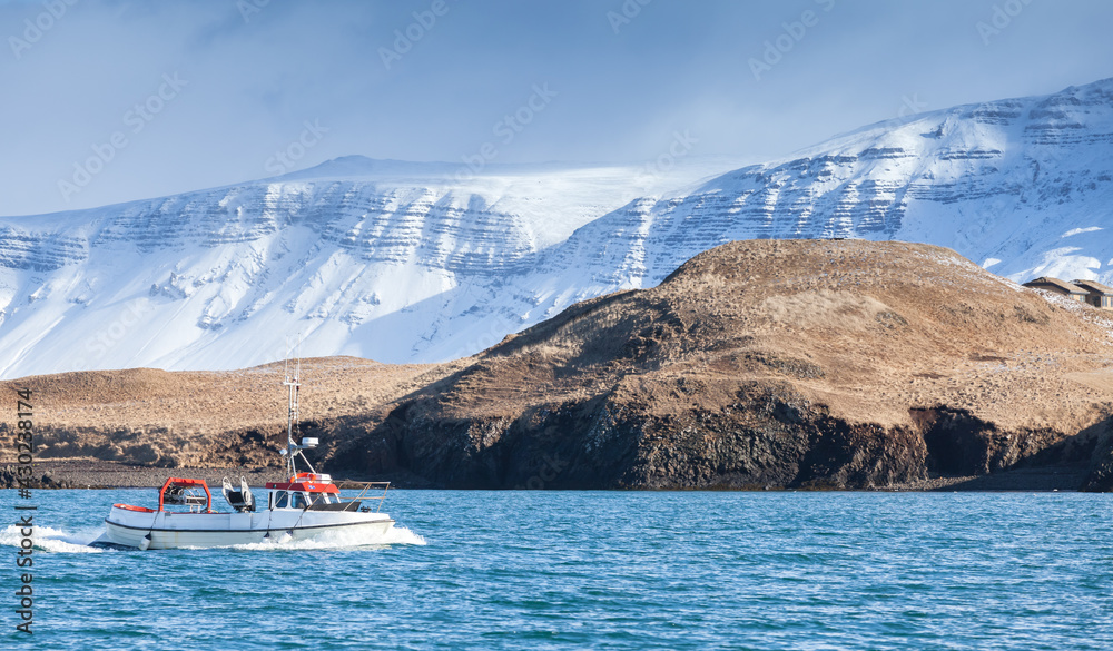 White fishing boat goes on the bay of Reykjavik