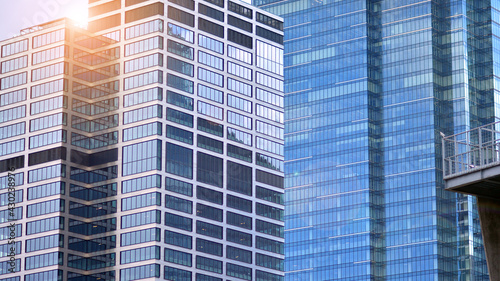 Modern office building detail, glass surface on a clear sky background. Transparent glass wall of office building. 