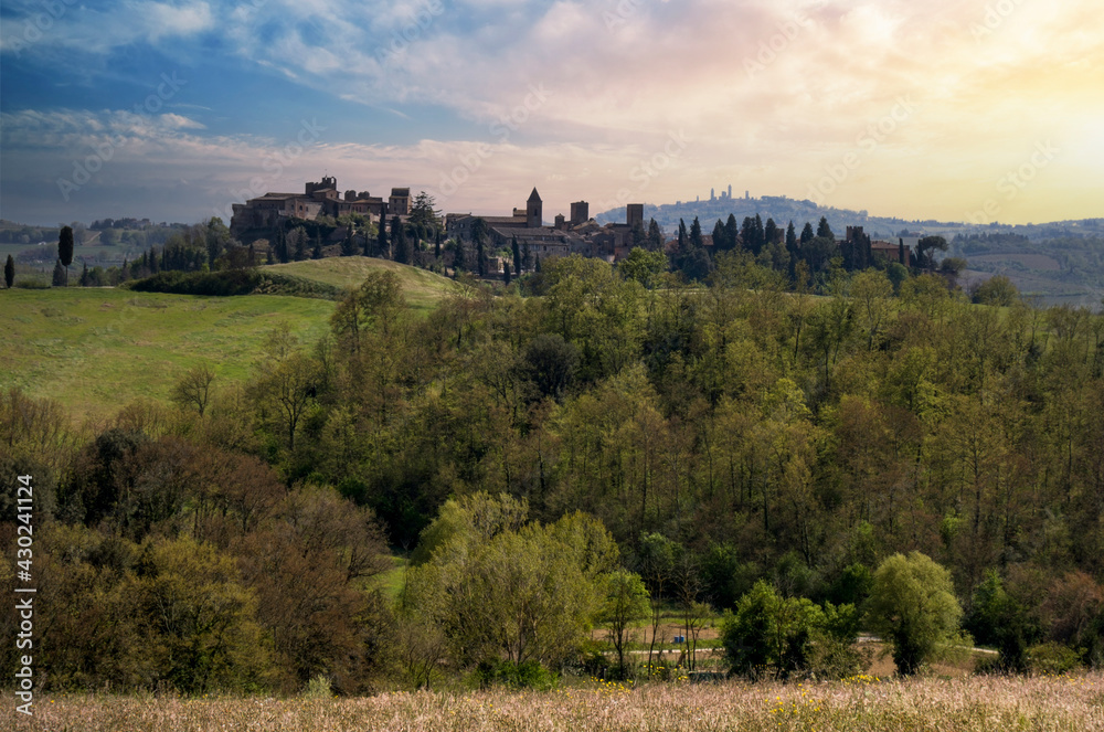 medieval town of certaldo and in the background the town of san gimignano at sunset