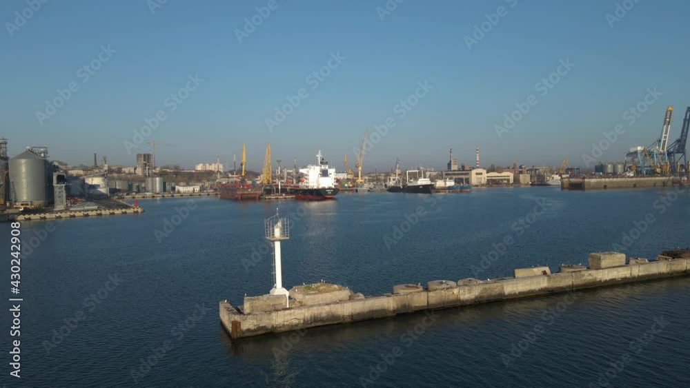 Aerial view of a cargo ship in the port dock Trade Export. Loading and unloading in deep water port, Aerial view of business logistics import and export cargo transportation Aerial view of a cargo ship in the port dock Trade Export. Loading and unloading in deep water port, Aerial view of business logistics import and export cargo transportation