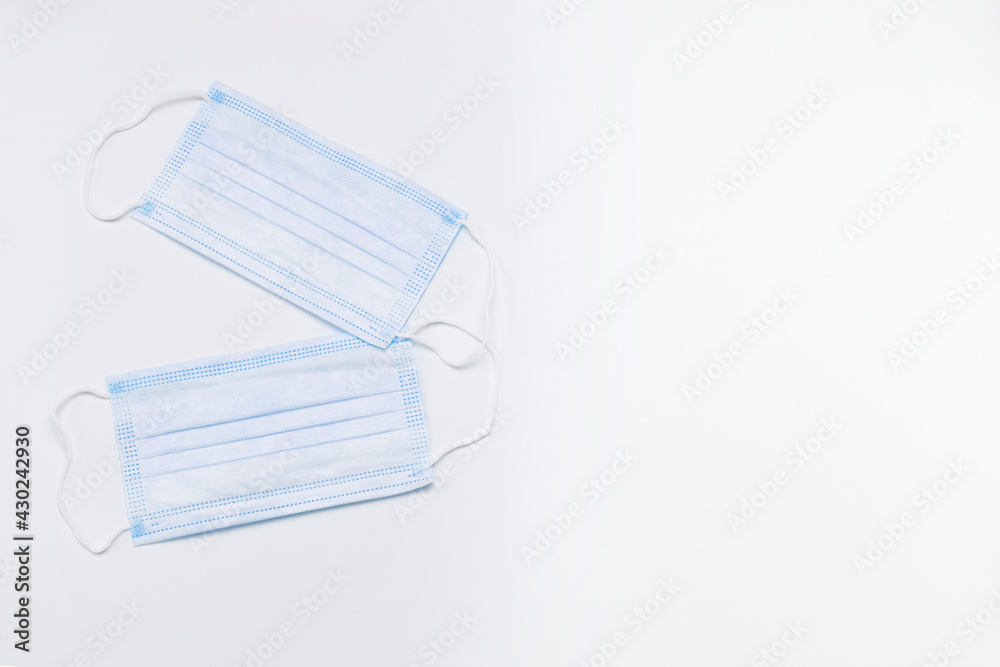 two medical disposable masks on a white background