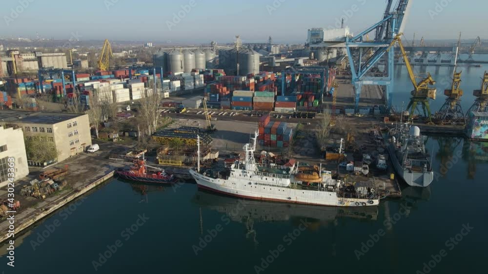 Aerial view of a cargo ship in the port dock Trade Export. Loading and unloading in deep water port, Aerial view of business logistics import and export cargo transportation Aerial view of a cargo ship in the port dock Trade Export. Loading and unloading in deep water port, Aerial view of business logistics import and export cargo transportation