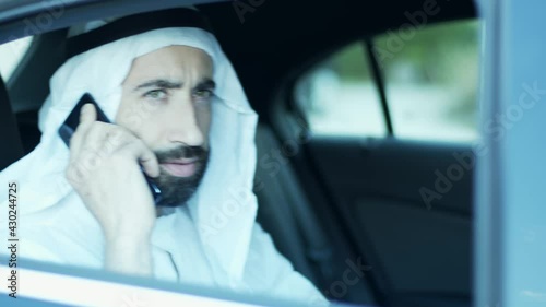 The sheik on the phone arrives with the driver driving the car. International affairs.