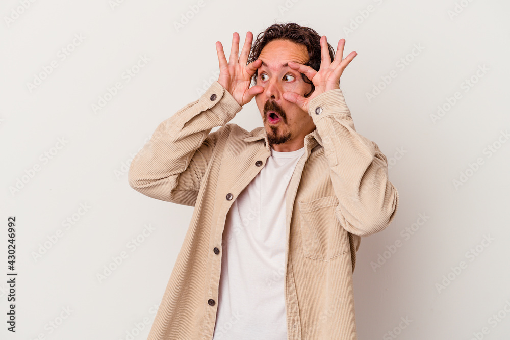 Young caucasian man isolated on white background keeping eyes opened to find a success opportunity. Young caucasian man isolated on white background keeping eyes opened to find a success opportunity.