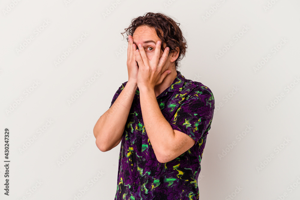 Young caucasian man isolated on white background blink through fingers frightened and nervous. Young caucasian man isolated on white background blink through fingers frightened and nervous.