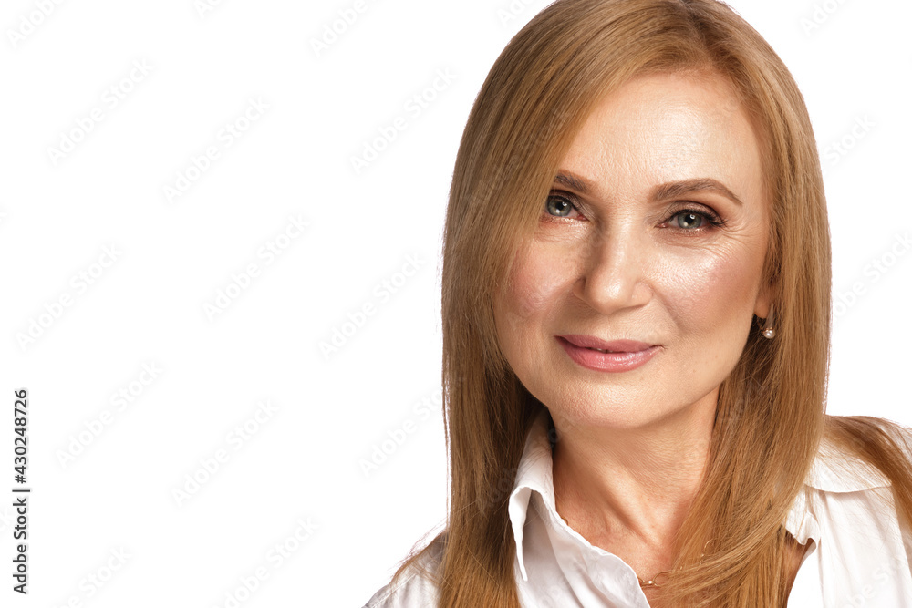 Portrait of a beautiful elderly woman in a white shirt with classic makeup and blond hair. Portrait of a beautiful elderly woman in a white shirt with classic makeup and blond hair.