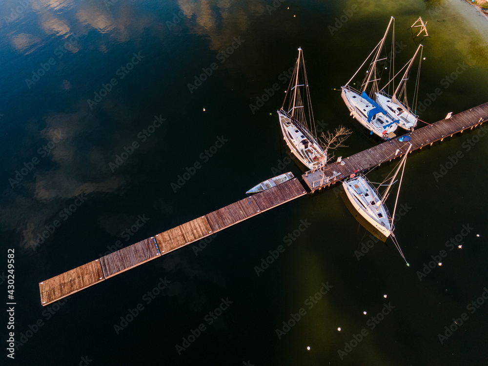 marina for boats, wooden footbridge, Masurian lakes. Aerial view, photos from the drone - obrazy, fototapety, plakaty 