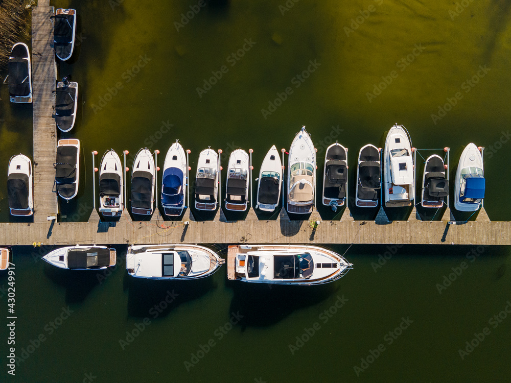 marina for boats, wooden footbridge, Masurian lakes. Aerial view, photos from the drone - obrazy, fototapety, plakaty 