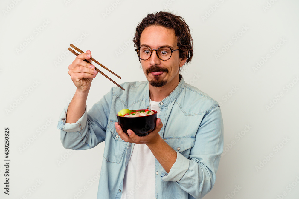 Young caucasian man eating a ramen isolated on white background Young caucasian man eating a ramen isolated on white background