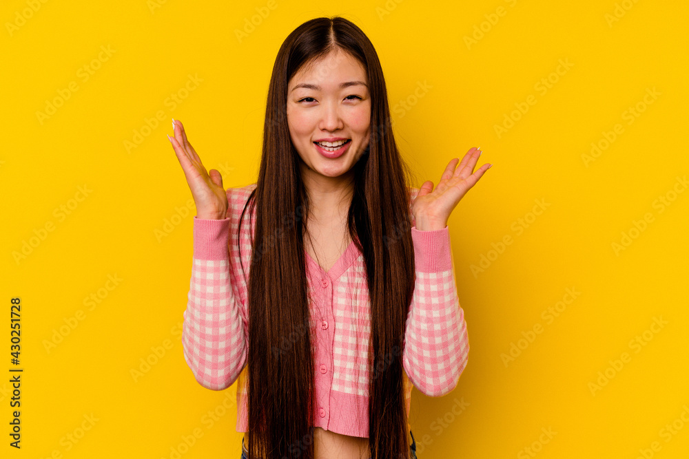 Young chinese woman isolated on yellow background joyful laughing a lot. Happiness concept. Young chinese woman isolated on yellow background joyful laughing a lot. Happiness concept.