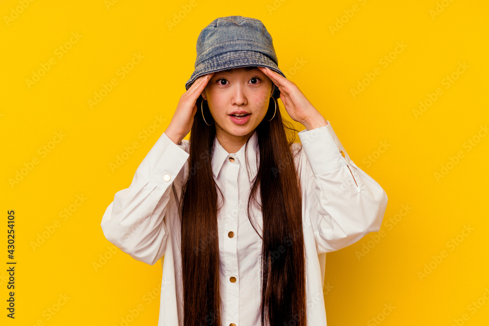 Young chinese woman isolated on yellow background receiving a pleasant surprise, excited and raising hands. Young chinese woman isolated on yellow background receiving a pleasant surprise, excited and raising hands.