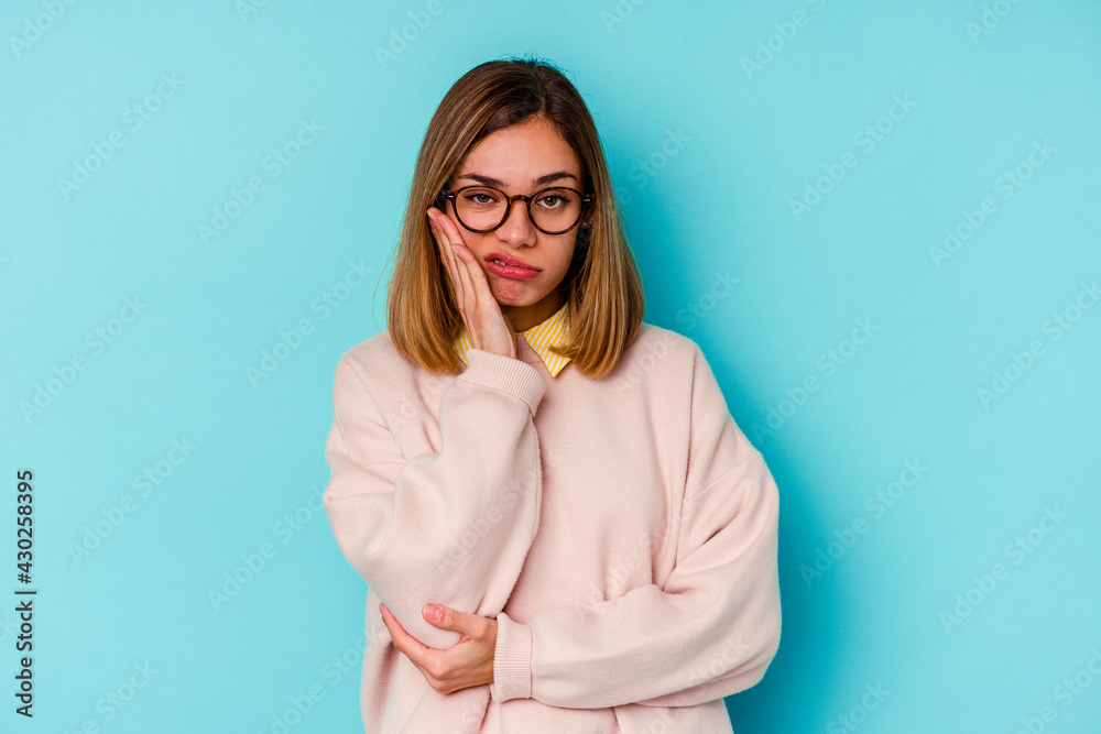 Fototapeta premium Young student caucasian woman isolated on blue background who is bored, fatigued and need a relax day.