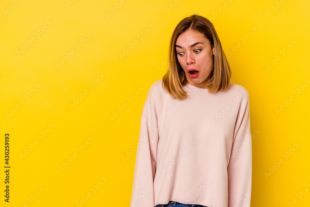 © Asier - Young caucasian skinny woman isolated on yellow background being shocked because of something she has seen. © Asier - Young caucasian skinny woman isolated on yellow background being shocked because of something she has seen.