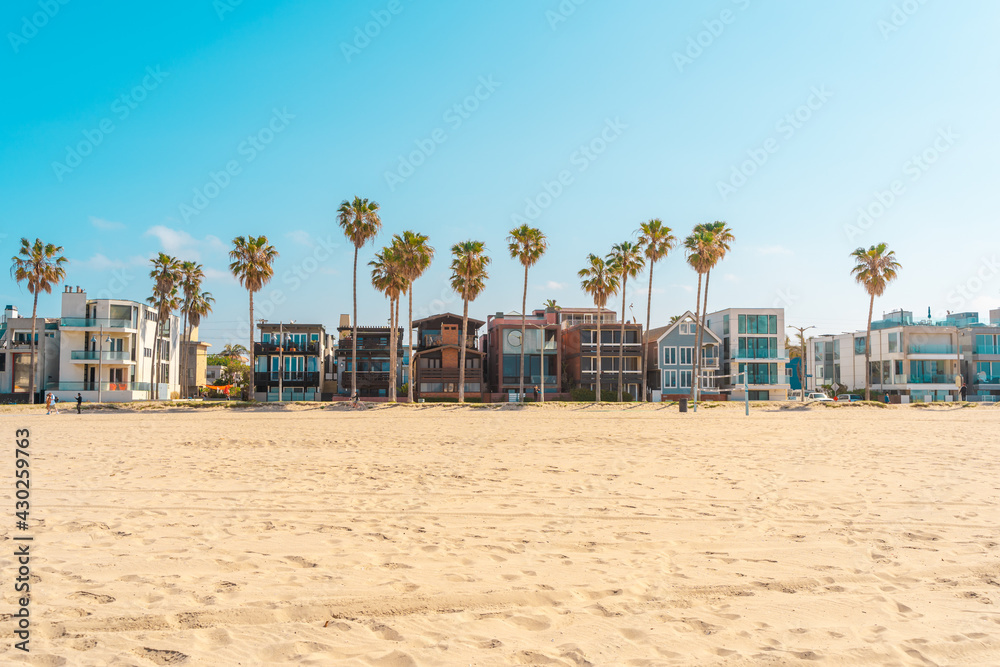 Sandy beach at Venice Beach in Los Angeles, blue lifeguard towers on a sunny day