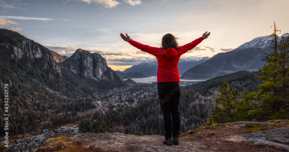 Adventurous Woman Hiking in the mountains during a Spring Sunset. Taken Squamish, North of Vancouver, British Columbia, Canada. Concept: Adventure, freedom, lifestyle Adventurous Woman Hiking in the mountains during a Spring Sunset. Taken Squamish, North of Vancouver, British Columbia, Canada. Concept: Adventure, freedom, lifestyle