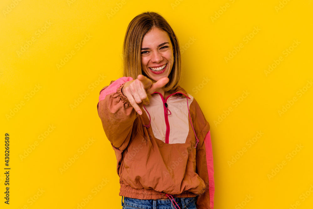 Young caucasian skinny woman isolated on yellow background pointing to front with fingers. Young caucasian skinny woman isolated on yellow background pointing to front with fingers.