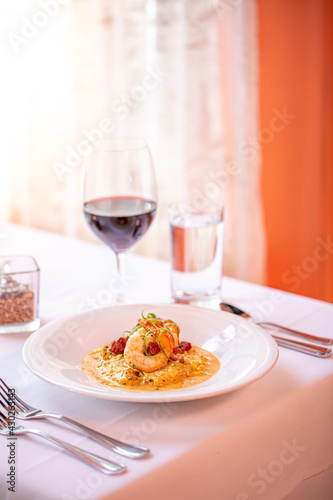 shrimp and grits served with red wine at a fine dining restaurant