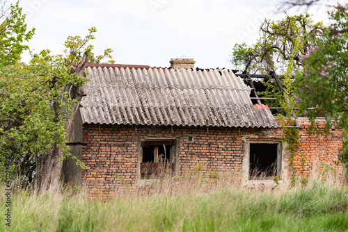 Old village house near Krakow. Abandoned brick house after fire. Old slate and charred beams.