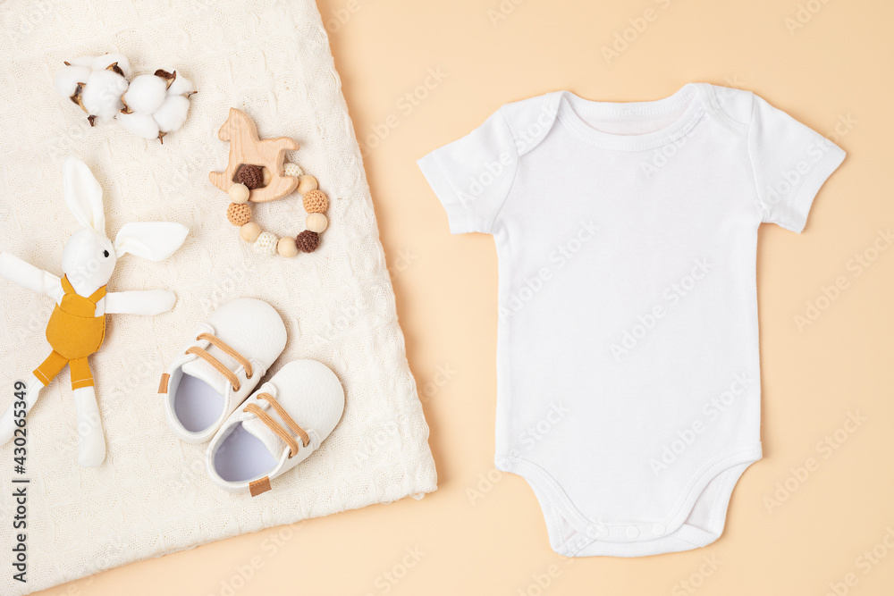 Mockup of white infant bodysuit made of organic cotton with eco friendly baby accessories - obrazy, fototapety, plakaty 