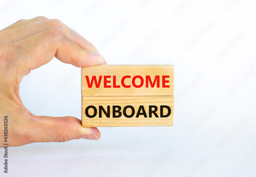 Welcome onboard symbol. Wooden blocks with words 'Welcome onboard' on beautiful white background. Businessman hand. Business and welcome onboard concept. Copy space.