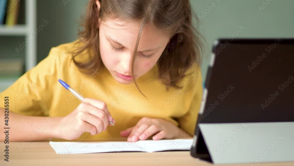 Cute child use laptop for education, online study, home studying. Girl have homework at home schooling. Cute child use laptop for education, online study, home studying. Girl have homework at home schooling.