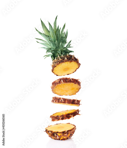Flying fresh ripe flying pineapple slices isolated on white background
