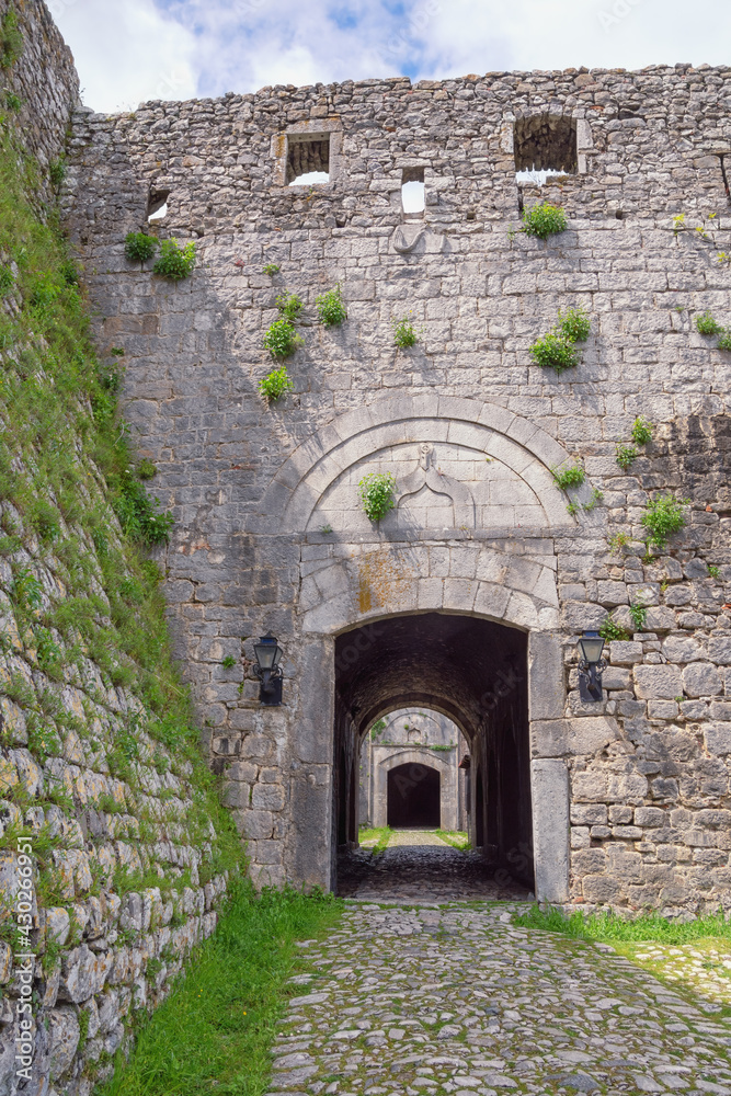 Ancient fortifications in Balkans. Albania, Shkoder city, Rozafa fort. Old stone wall and entrance to fortress Ancient fortifications in Balkans. Albania, Shkoder city, Rozafa fort. Old stone wall and entrance to fortress