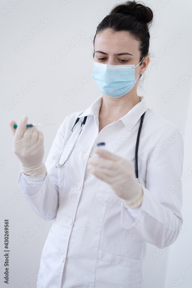 Female Doctor preparing the coronavirus COVID-19 vaccine Female Doctor preparing the coronavirus COVID-19 vaccine