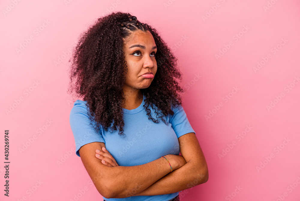 Young african american woman isolated on pink background tired of a repetitive task. Young african american woman isolated on pink background tired of a repetitive task.
